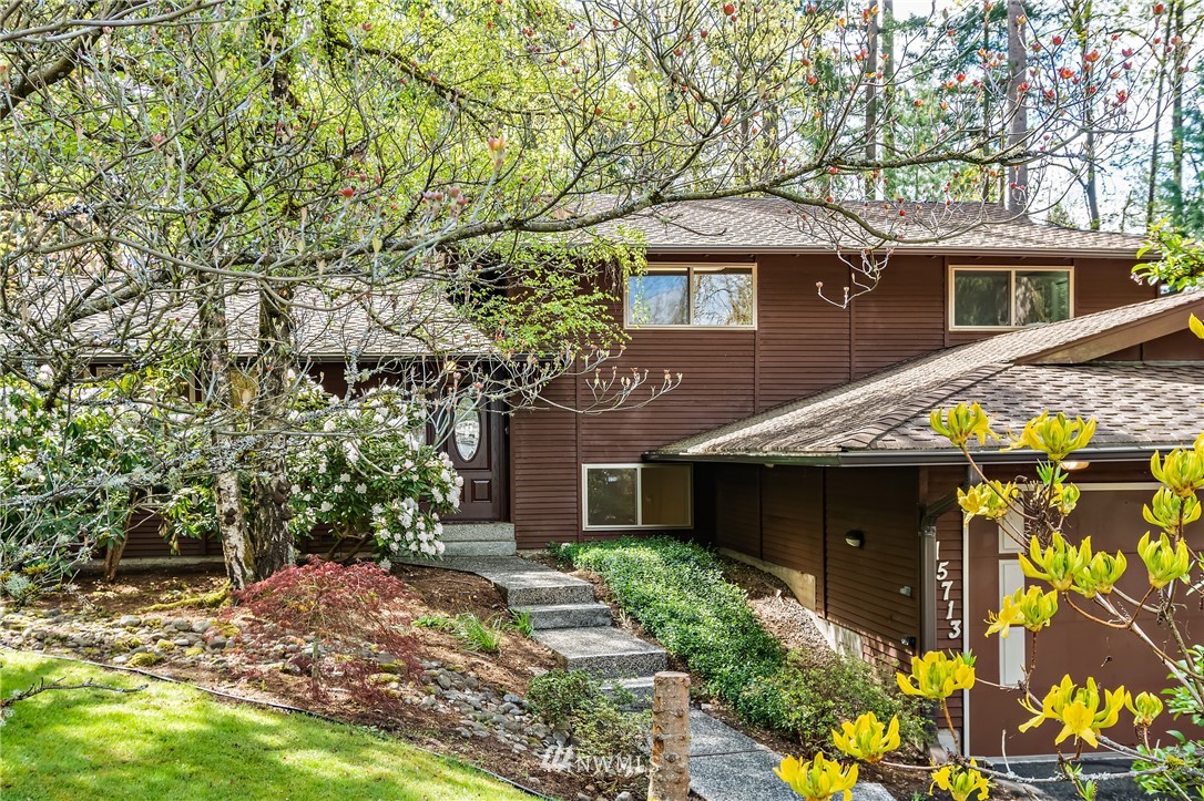 15713 Southeast 148th Street Renton, WA 98059 - Photo 1 of 39 a front view of a house with garden