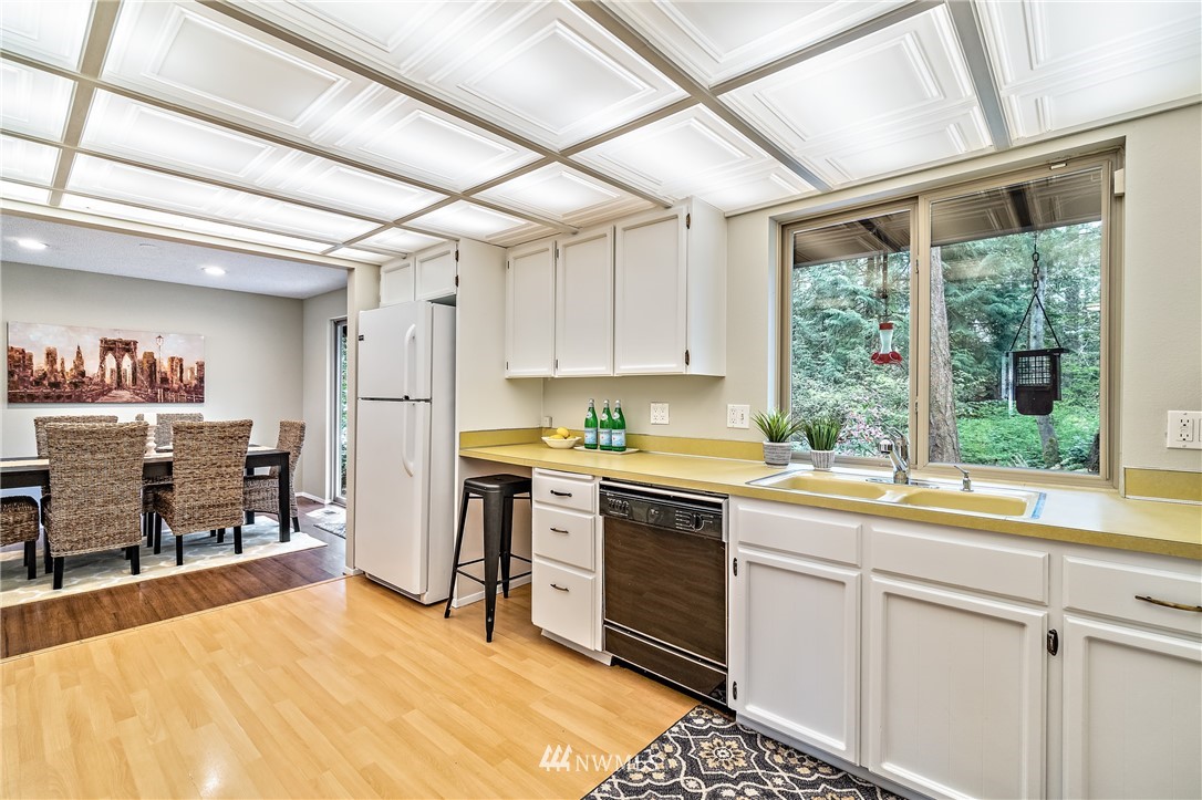 15713 Southeast 148th Street Renton, WA 98059 - Photo 15 of 39 a kitchen with a sink stove and cabinets