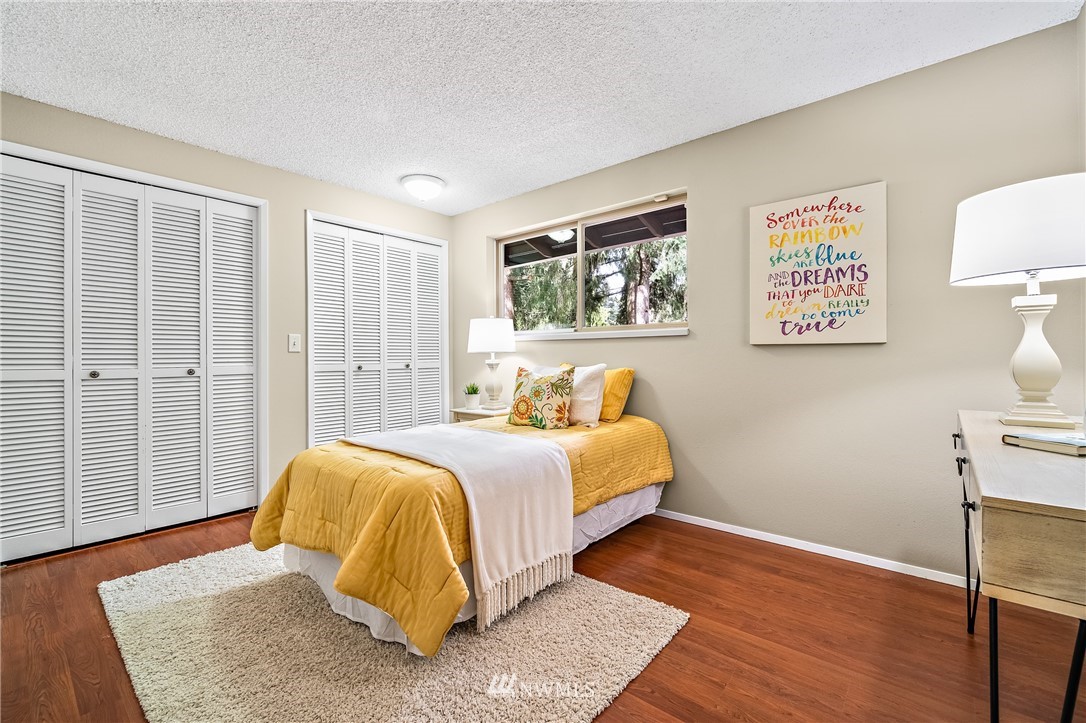 15713 Southeast 148th Street Renton, WA 98059 - Photo 20 of 39 a bedroom with a bed and wooden floor