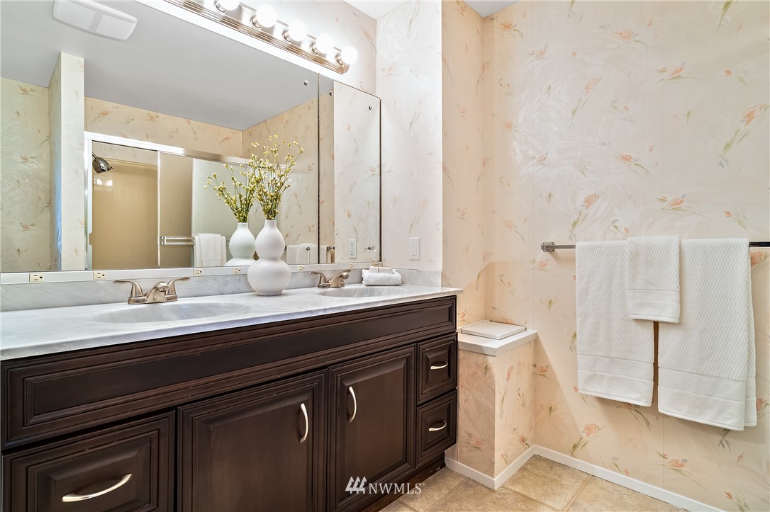 15713 Southeast 148th Street Renton, WA 98059 - Photo 21 of 39 a bathroom with a double vanity sink a mirror and a shower