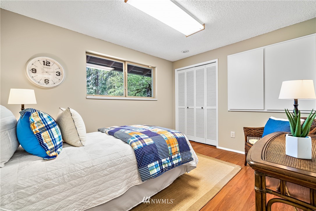 15713 Southeast 148th Street Renton, WA 98059 - Photo 22 of 39 a bedroom with a bed and a table in it with window