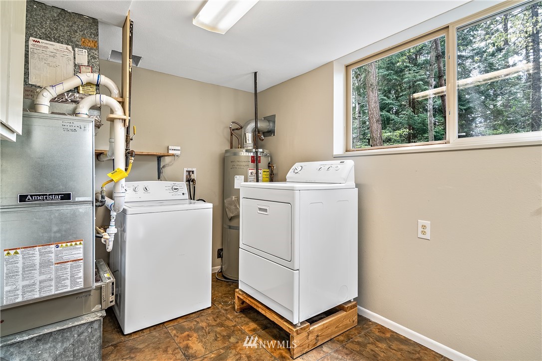 15713 Southeast 148th Street Renton, WA 98059 - Photo 24 of 39 a view of storage and utility room with washer and dryer