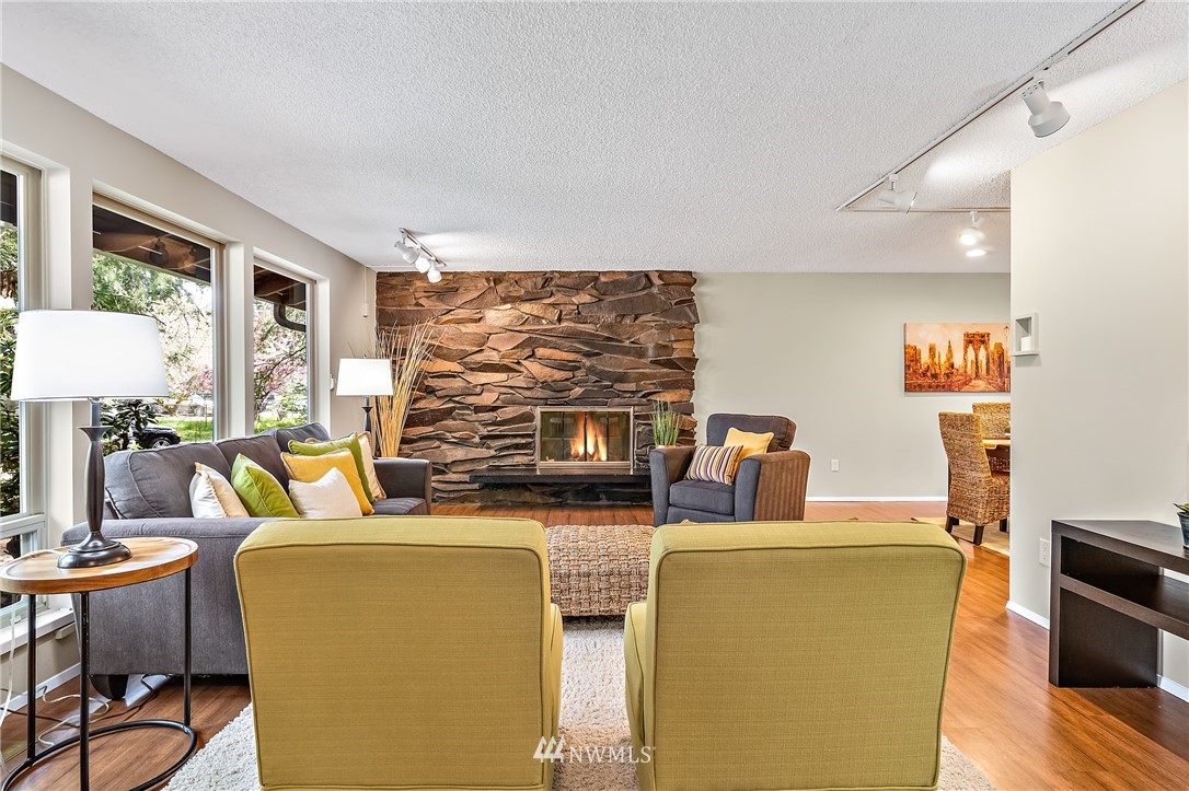 15713 Southeast 148th Street Renton, WA 98059 - Photo 8 of 39 a living room with furniture a fireplace and a flat screen tv
