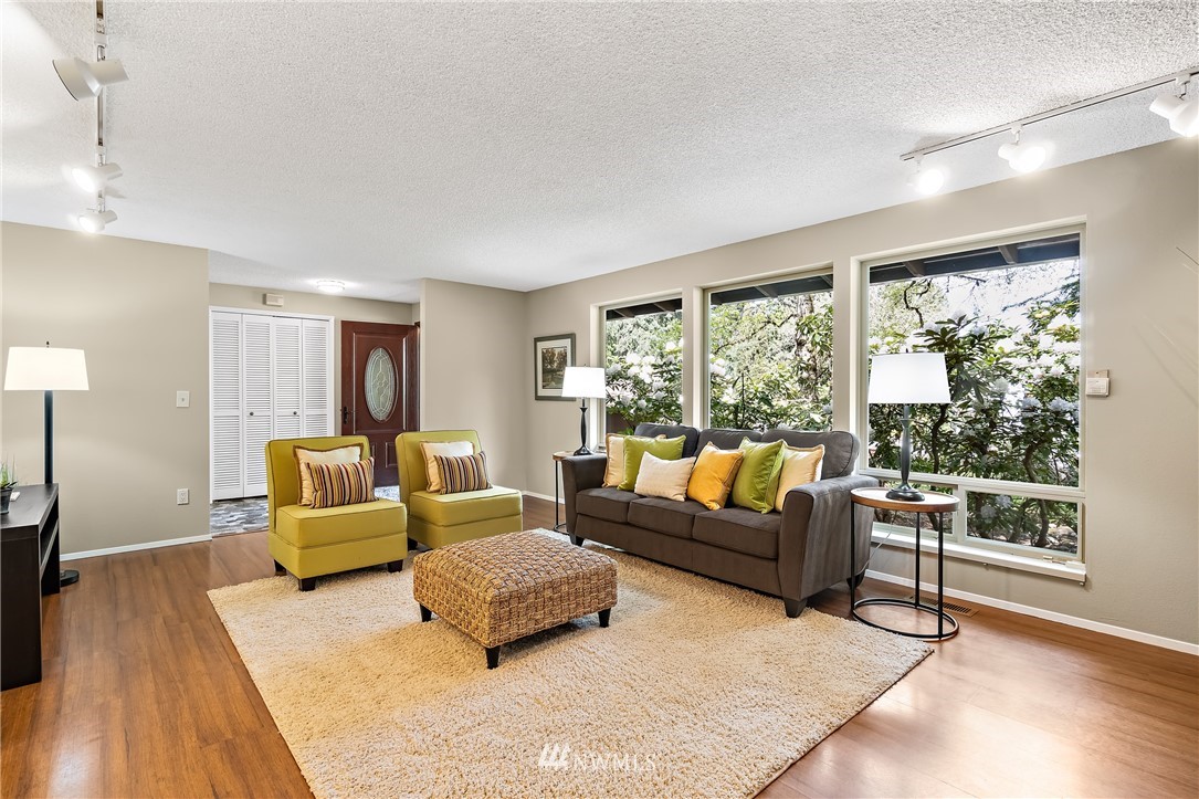 15713 Southeast 148th Street Renton, WA 98059 - Photo 9 of 39 a living room with furniture and a large window