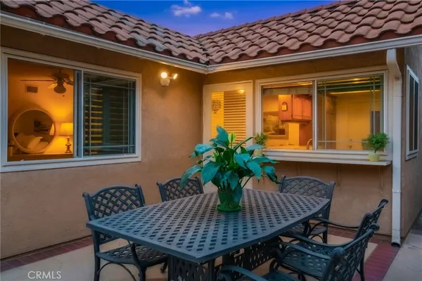 a view of a chairs and table in the patio