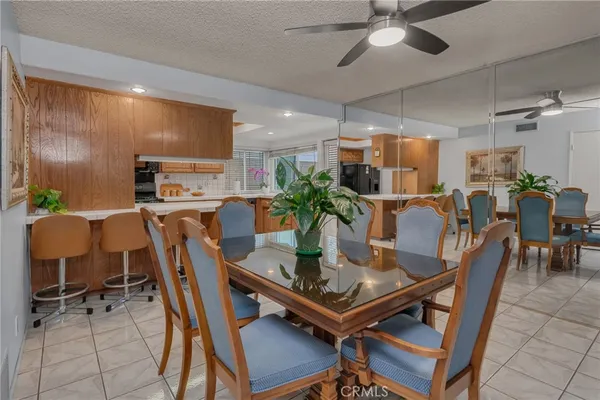 a kitchen with a sink a counter top space stainless steel appliances and cabinets