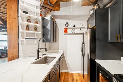 a kitchen with a refrigerator and a sink