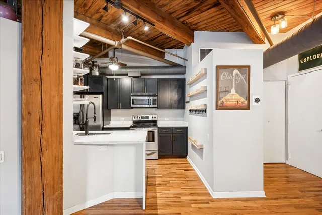 a kitchen with stainless steel appliances granite countertop a refrigerator and a stove