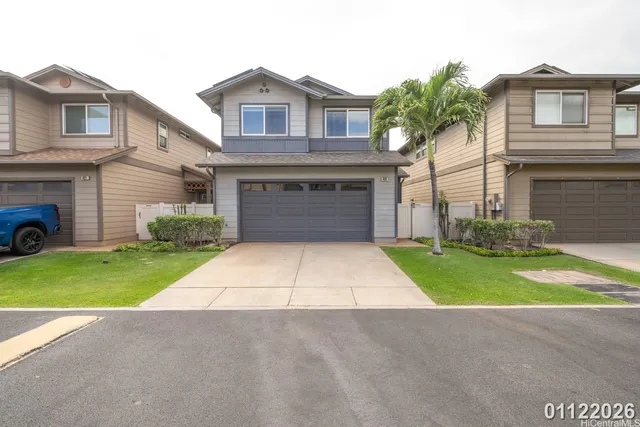 a front view of a house with a yard and a garage