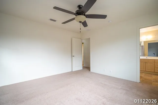 en empty room with ceiling fan and window