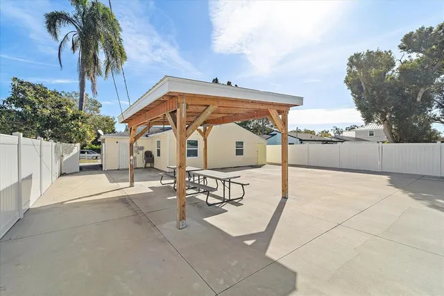 a view of a white house with a yard