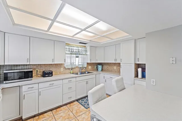a kitchen with a sink a stove and cabinets