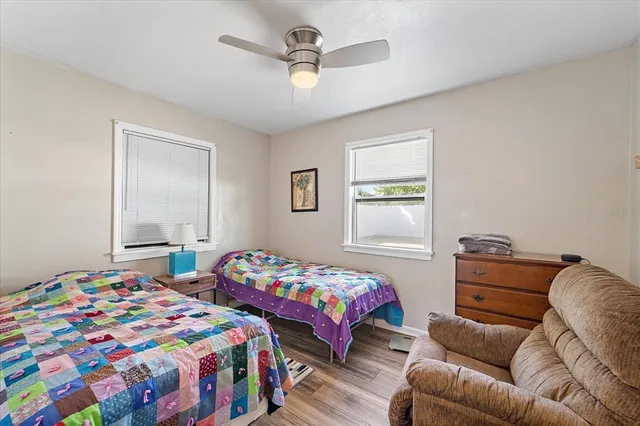 a bedroom with two beds and a window