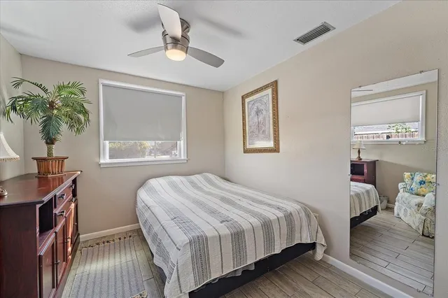 a bedroom with a bed and a painting on the wall