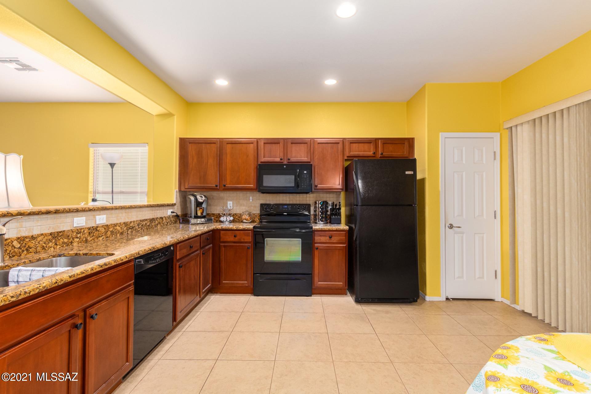 20894 East Founders Road Red Rock, AZ 85145 - Photo 8 of 27 a kitchen with stainless steel appliances granite countertop a refrigerator and a stove top oven