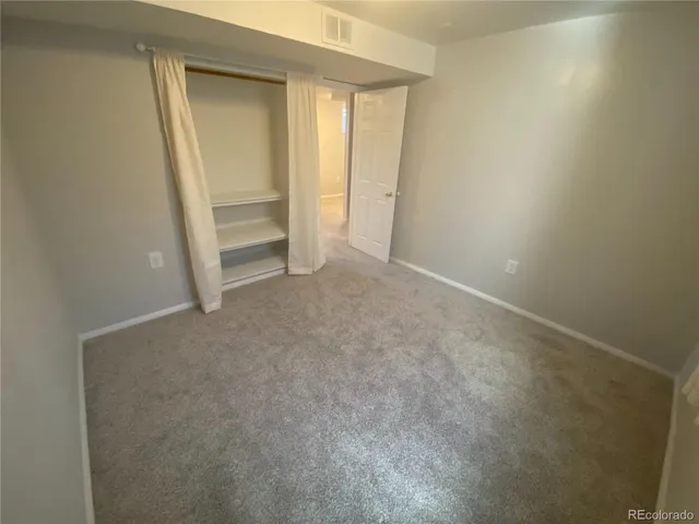 a view of an empty room and a sink