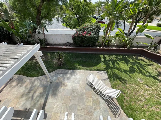 a view of yard from deck with patio