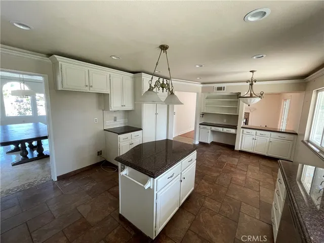 a kitchen with refrigerator and cabinets
