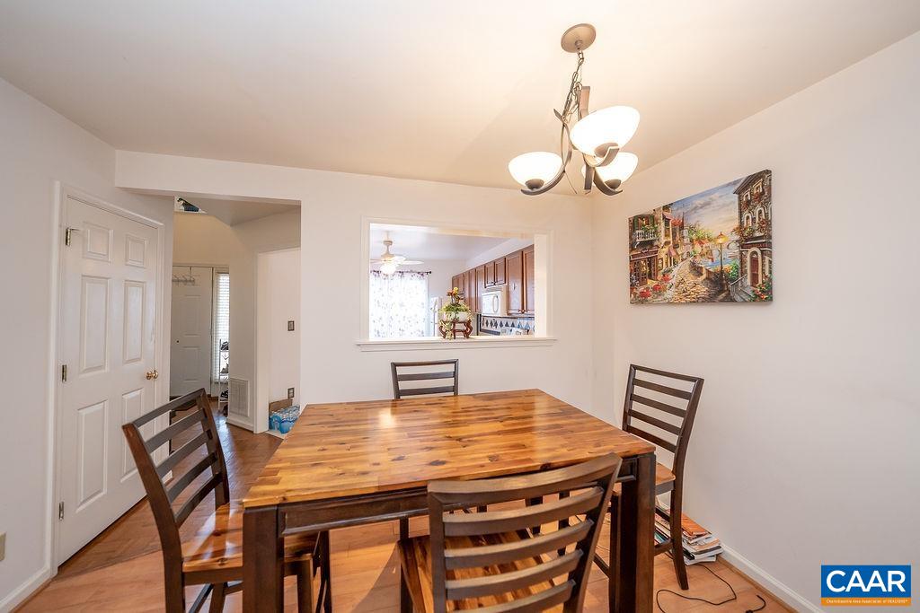 1302 Wimbledon Way Charlottesville, VA 22901 - Photo 15 of 60 a view of a dining room with furniture and chandelier