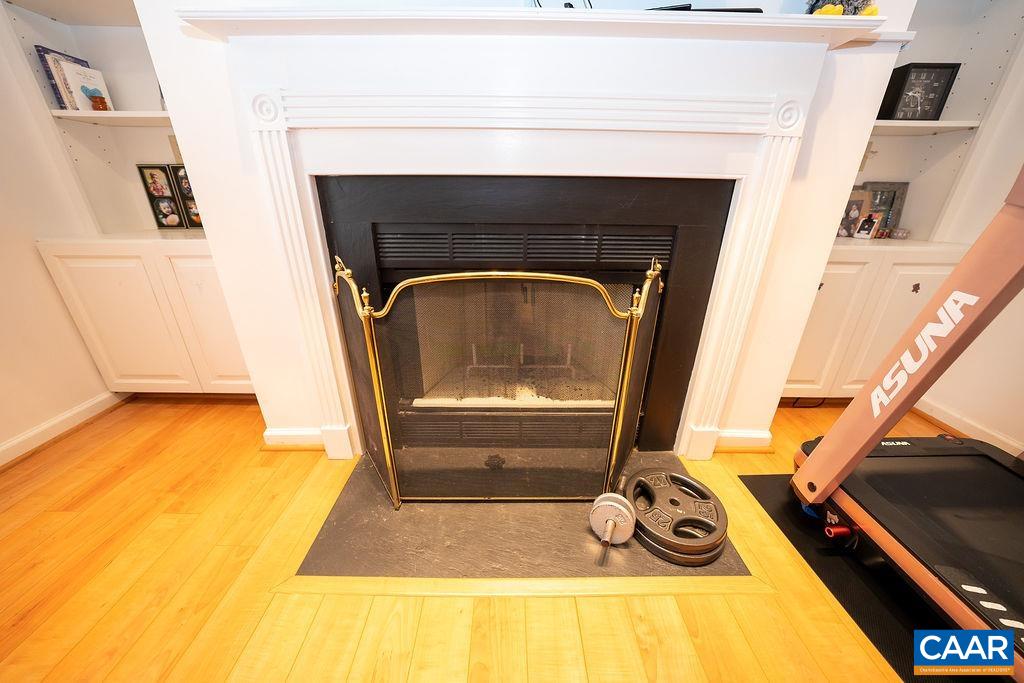 1302 Wimbledon Way Charlottesville, VA 22901 - Photo 21 of 60 a living room with a fireplace and a table