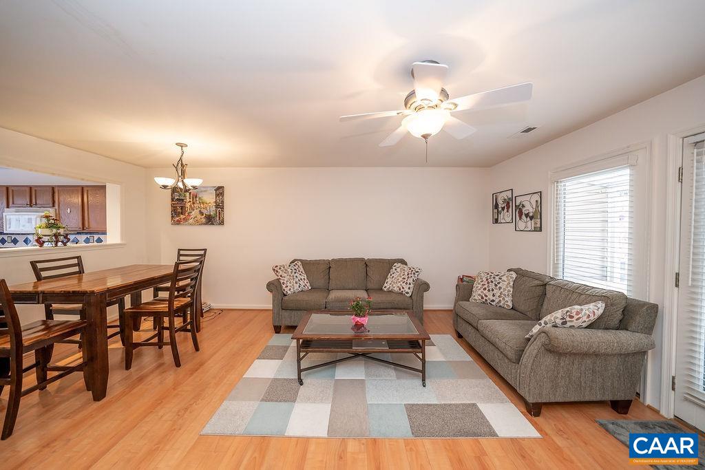 1302 Wimbledon Way Charlottesville, VA 22901 - Photo 22 of 60 a living room with furniture and a dining table with wooden floor