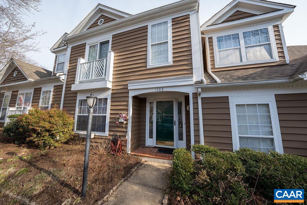 1302 Wimbledon Way Charlottesville, VA 22901 - Photo 31 of 60 a view of a house with large windows and flower plants
