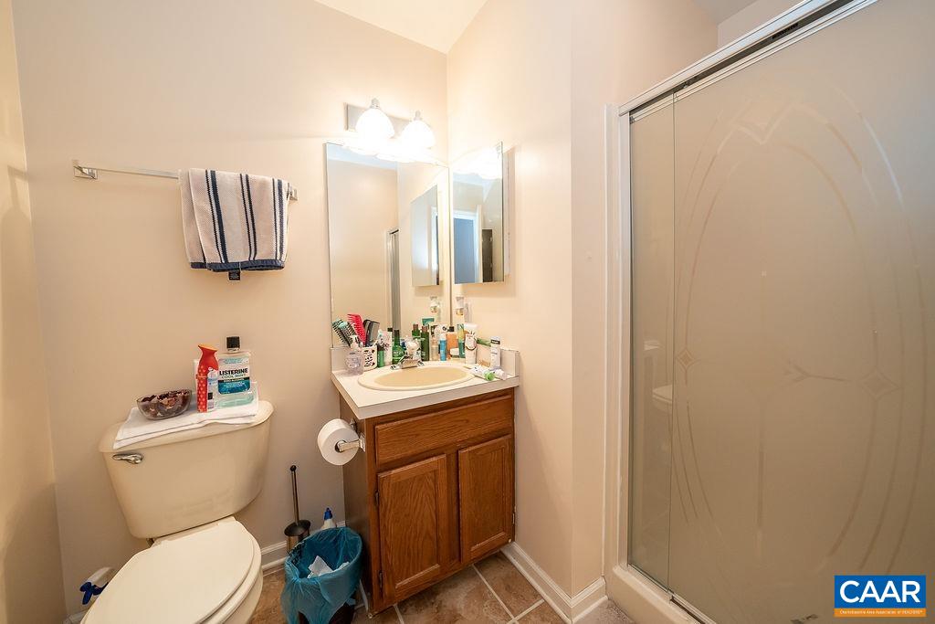 1302 Wimbledon Way Charlottesville, VA 22901 - Photo 35 of 60 a bathroom with a toilet a sink and mirror