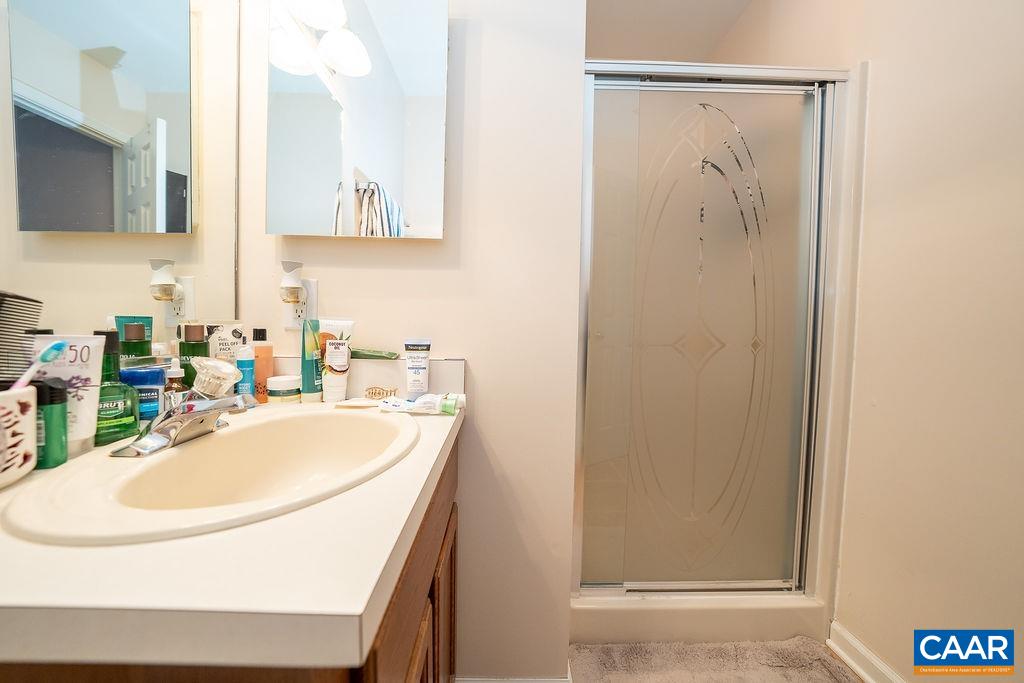 1302 Wimbledon Way Charlottesville, VA 22901 - Photo 36 of 60 a bathroom with a sink a mirror and a bathtub