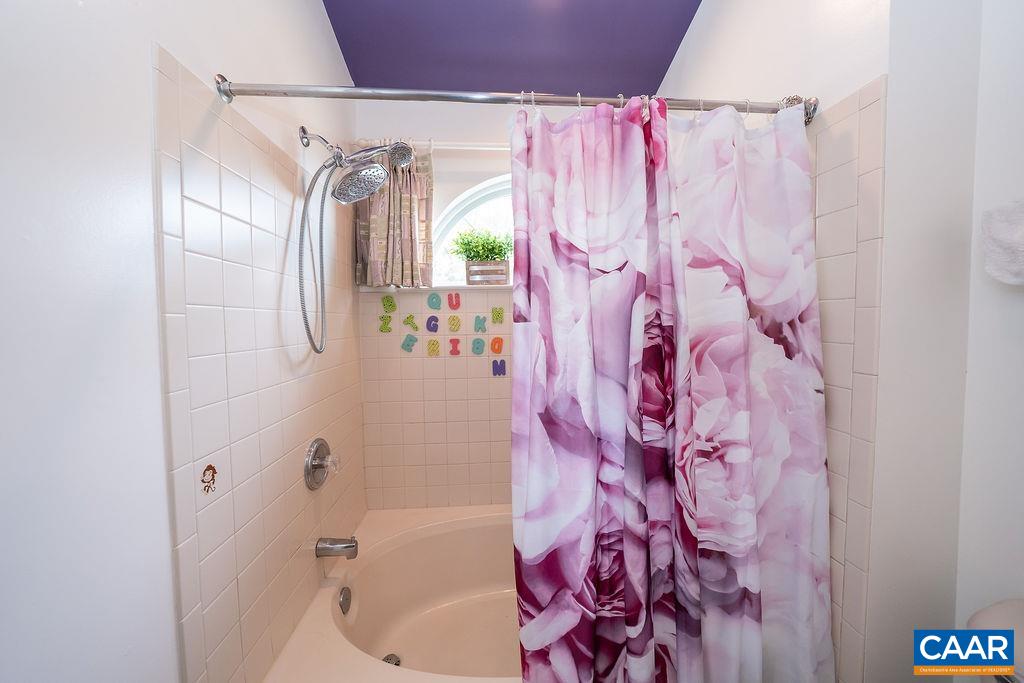 1302 Wimbledon Way Charlottesville, VA 22901 - Photo 46 of 60 a bathroom with a bathtub and shower curtain