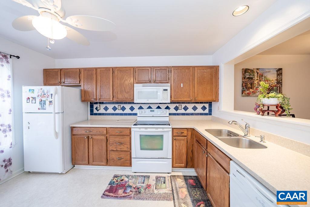 1302 Wimbledon Way Charlottesville, VA 22901 - Photo 9 of 60 a kitchen with a sink dishwasher a stove and a refrigerator with wooden floor