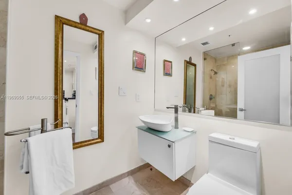 a bathroom with a double vanity sink mirror and