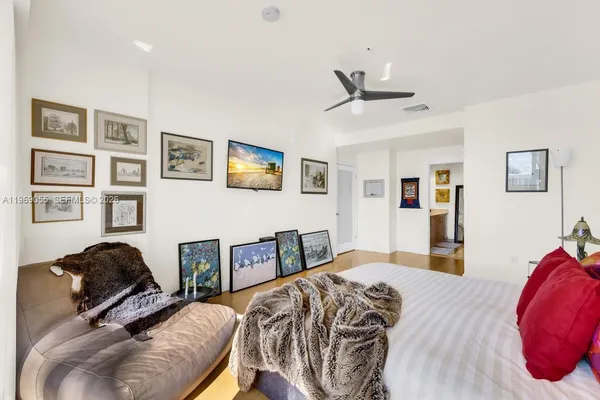 a bedroom with a bed and painting on the wall