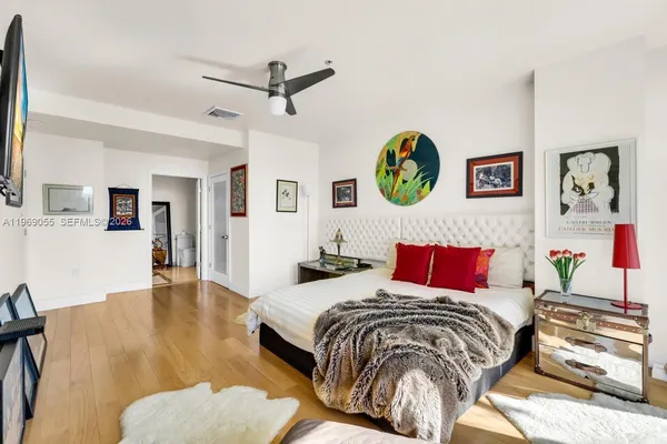 a spacious bathroom with double vanity sinks a large mirror and a shower