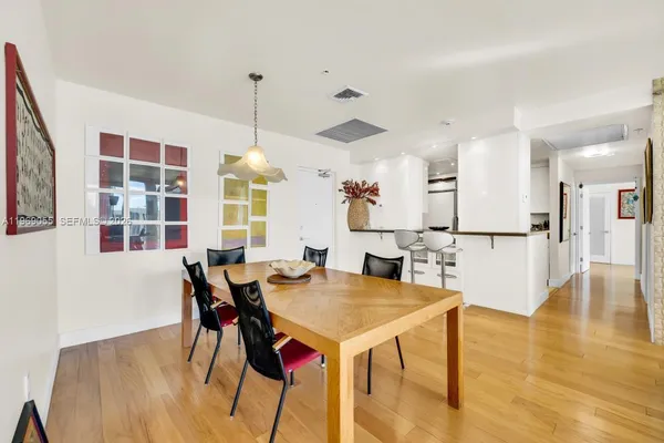 a view of a dining room with furniture and wooden floor