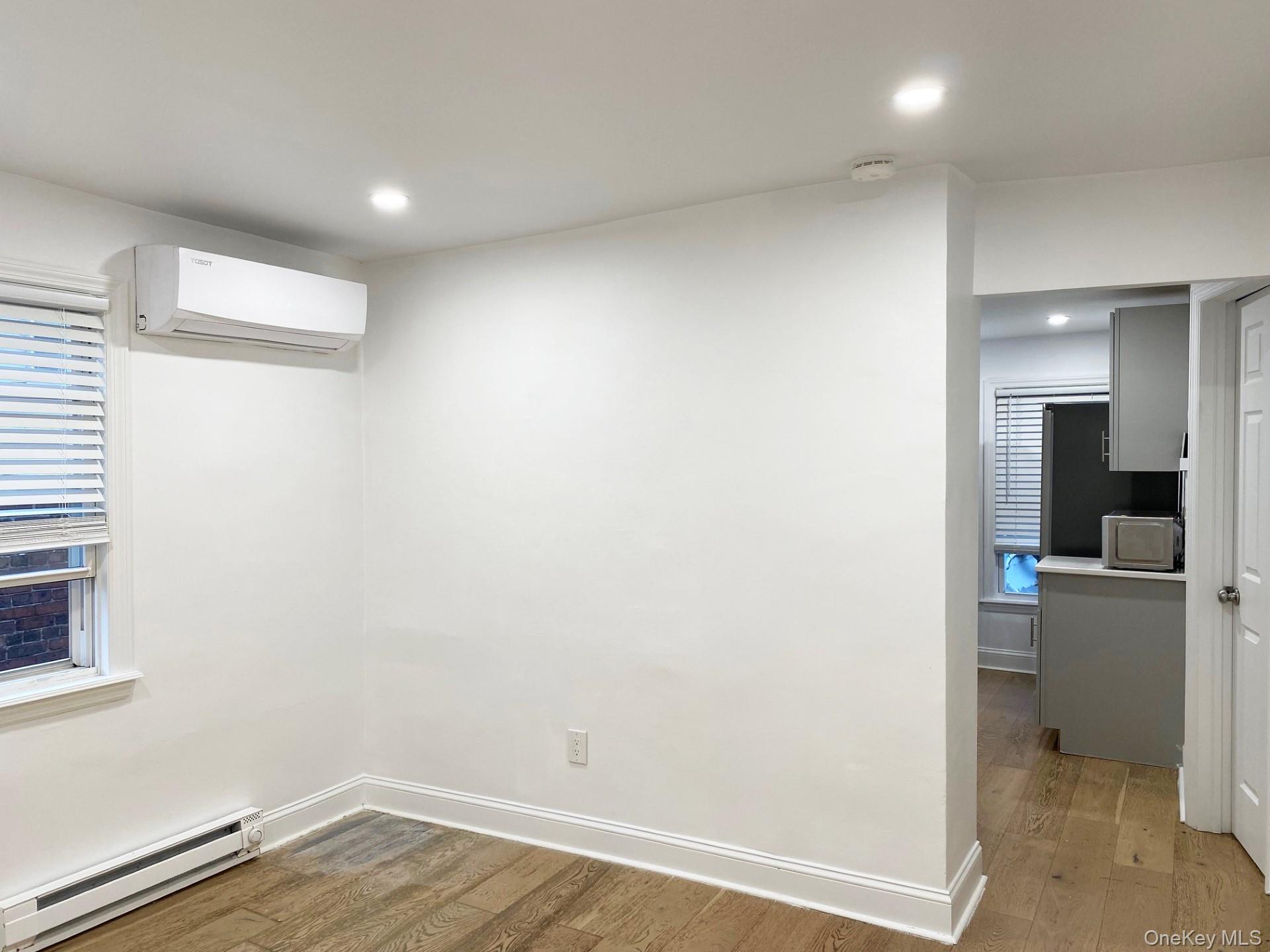 153 Southside Avenue Hastings-on-Hudson, NY 10706 - Photo 5 of 12 a view of a kitchen with a fridge and wooden floor