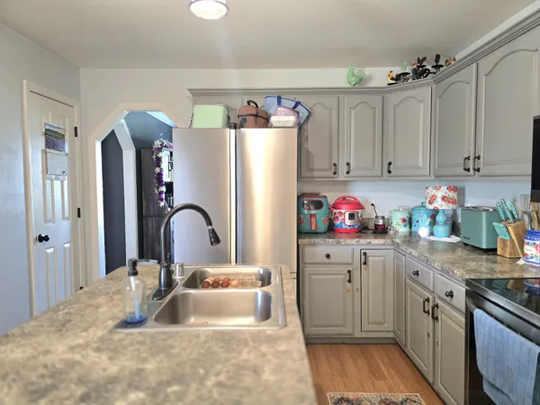 a kitchen with a sink cabinets and a refrigerator