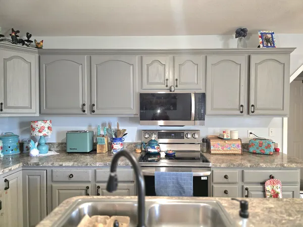 a kitchen with cabinets a sink and appliances