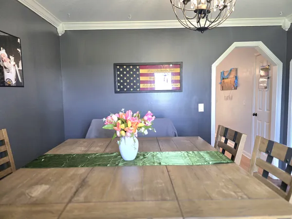 a view of a dining room with furniture and wooden floor