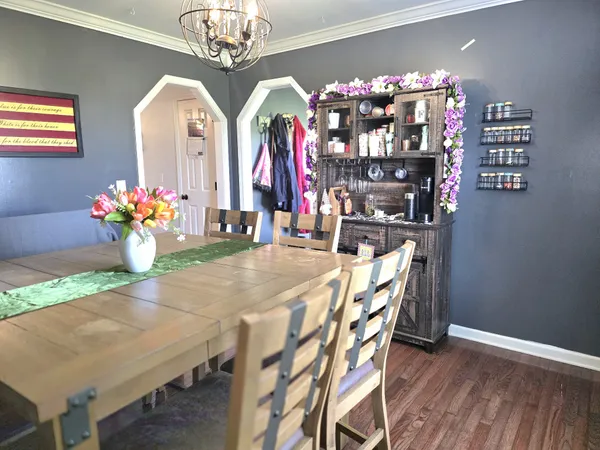 a dining room with furniture and chandelier