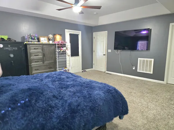 a bedroom with a bed and a television