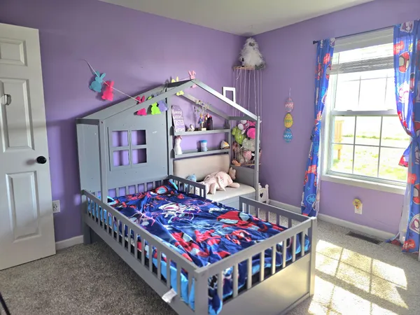 a bedroom with a bed and a dresser in it