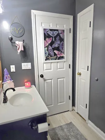 a bathroom with a sink mirror vanity and toilet