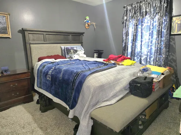 a bedroom with a bed and a mirror