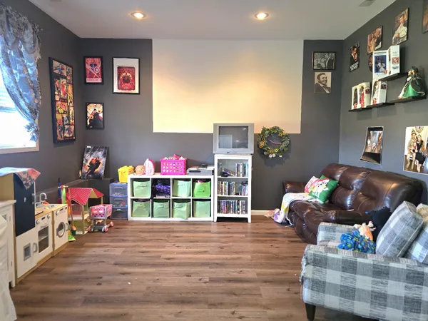 a living room with furniture and a wooden floor