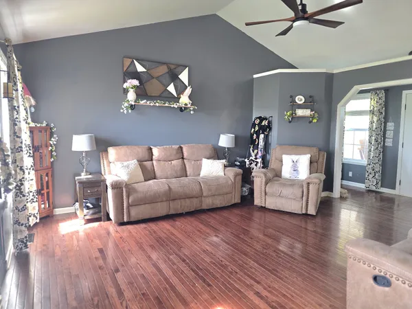 a living room with furniture and a wooden floor
