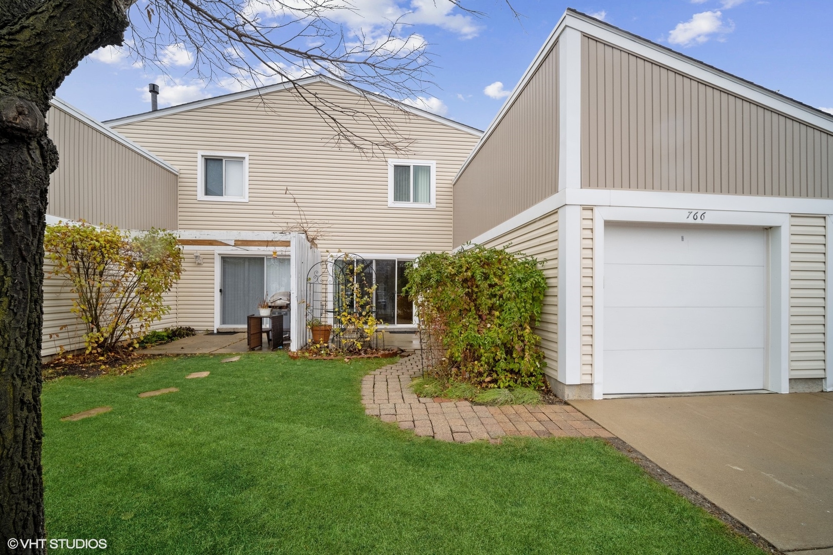 a view of a house with a backyard