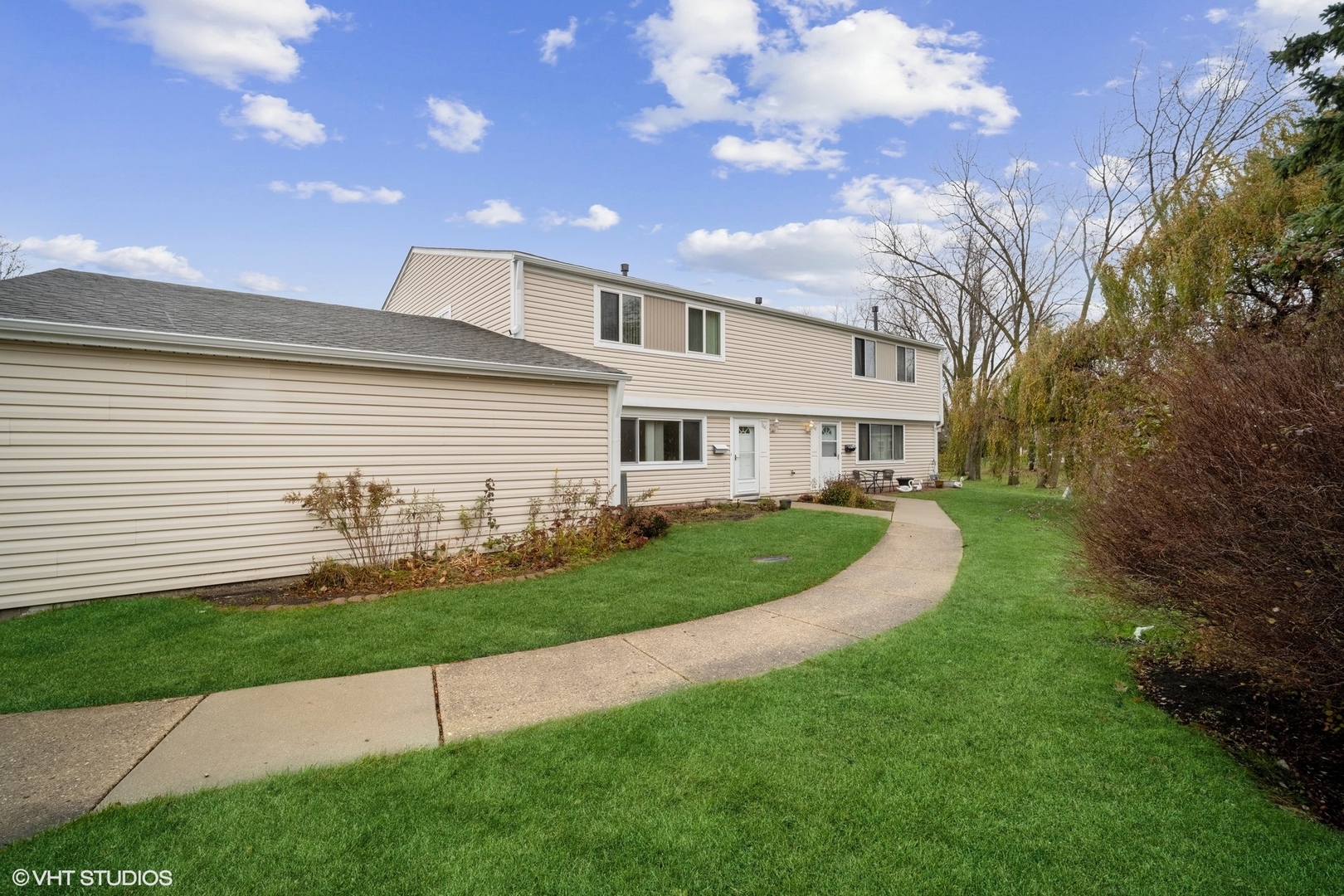 766 Barnaby Place Wheeling, IL 60090 - Photo 2 of 22 a front view of a house with a yard and garage