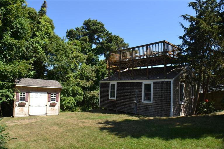 4 Seaview Road, Unit 5 Orleans, MA 02653 - Photo 4 of 17 a front view of a house with a garden and trees