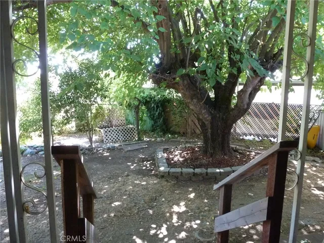 a view of a porch with furniture and a yard