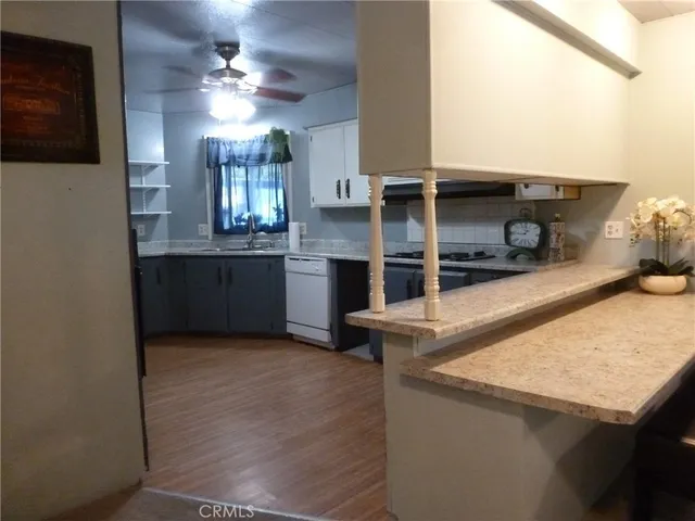 a kitchen with stainless steel appliances granite countertop a sink and a stove